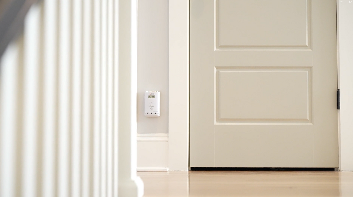 Beige door with a light switch on a white wall
