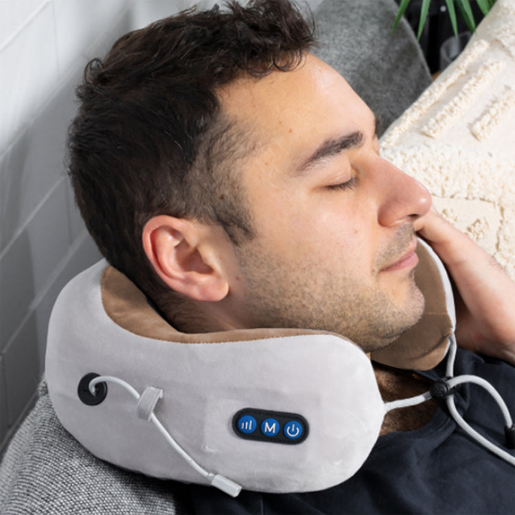 Man using a neck massager while lying down