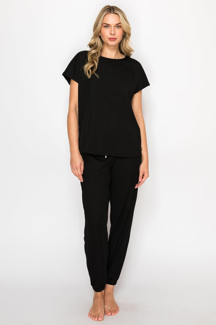 Woman wearing a black outfit on a white background