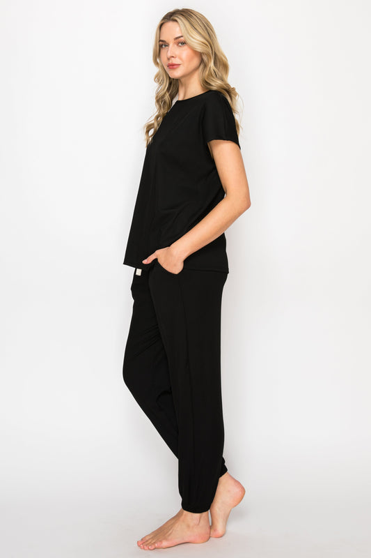 Woman wearing a black outfit with a white background