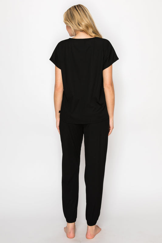 Woman wearing a black outfit with a white background