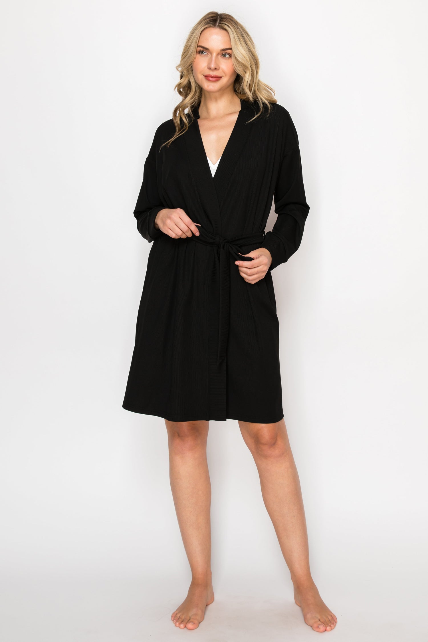 Woman wearing a black robe against a white background