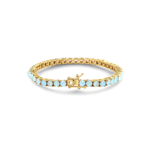 Gold bracelet with opal stones on a white background
