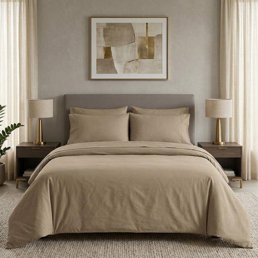 Purple bedding set on a bed with matching pillows in a room with purple walls and wooden nightstands.