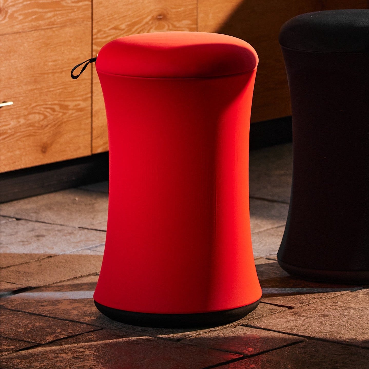 Red and black stools on a wooden floor