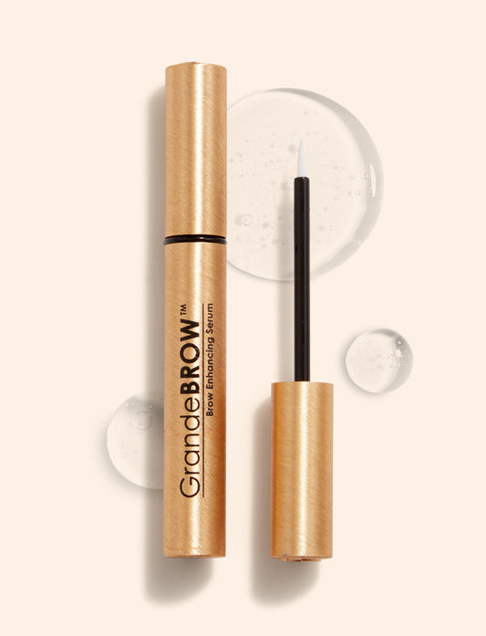 Three cosmetic products including a mascara, eyeliner, and hair serum on a white background