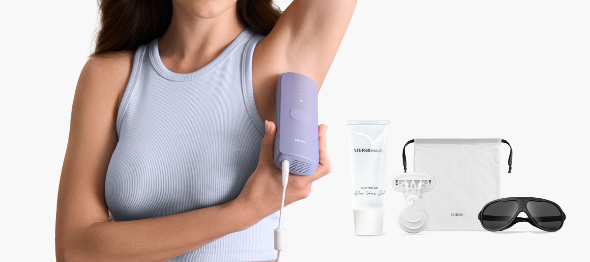 Woman using a purple electronic device on her arm with a bottle, pouch, and sunglasses in the foreground.