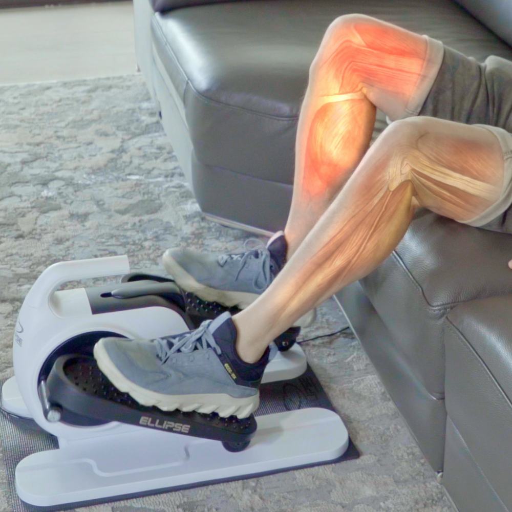 Person using an elliptical machine with a focus on leg muscles.