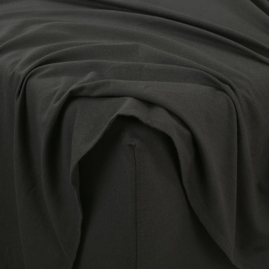 Dark gray bedding set on a bed with wooden headboard and nightstand in a bedroom setting.