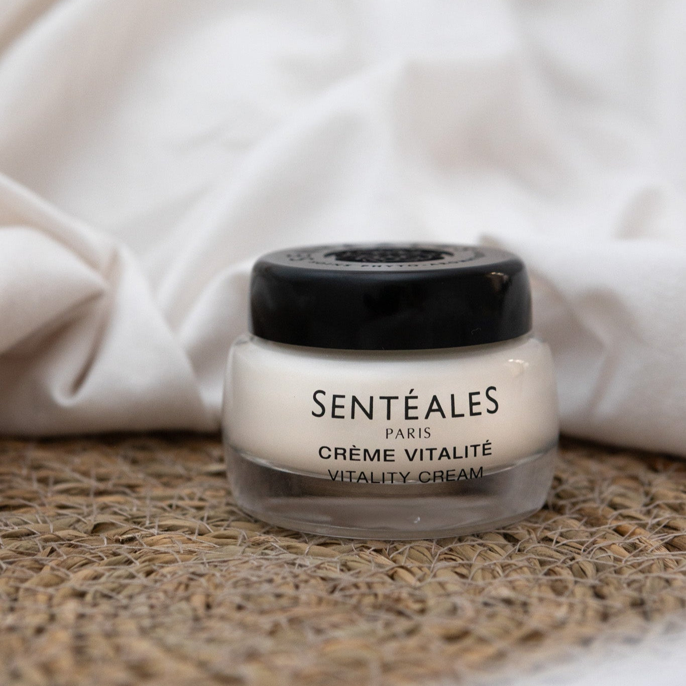 Jar of Sentéales Paris Crème Vitalité on a textured surface with a white fabric background