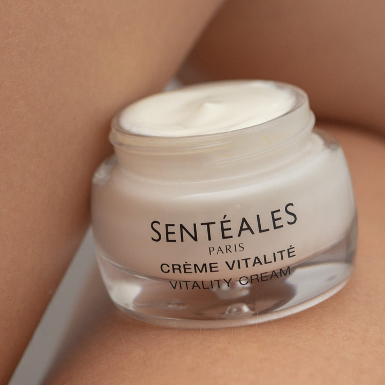 Jar of Sentéales Paris Crème Vitalité cream on a skin background