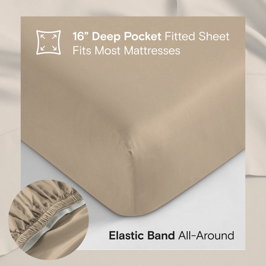 Beige bedding set on a bed with pillows in a bright room with large windows.