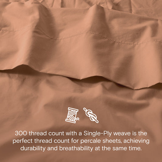 Brown bedspread set on a bed in a well-lit room with decor elements.