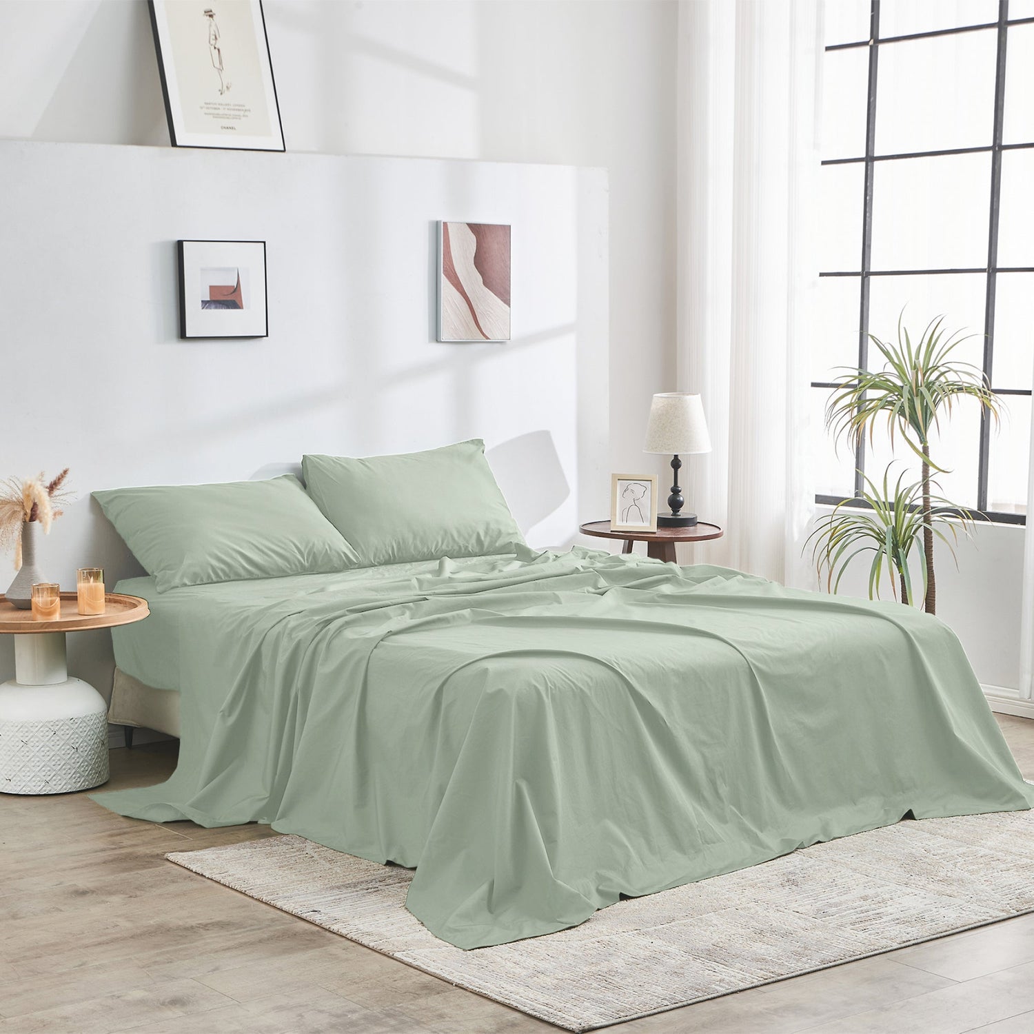 Green bedspread set on a bed in a bright bedroom with decor elements.