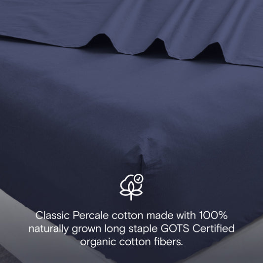 Navy blue bedding set on a bed in a modern bedroom with decor elements.