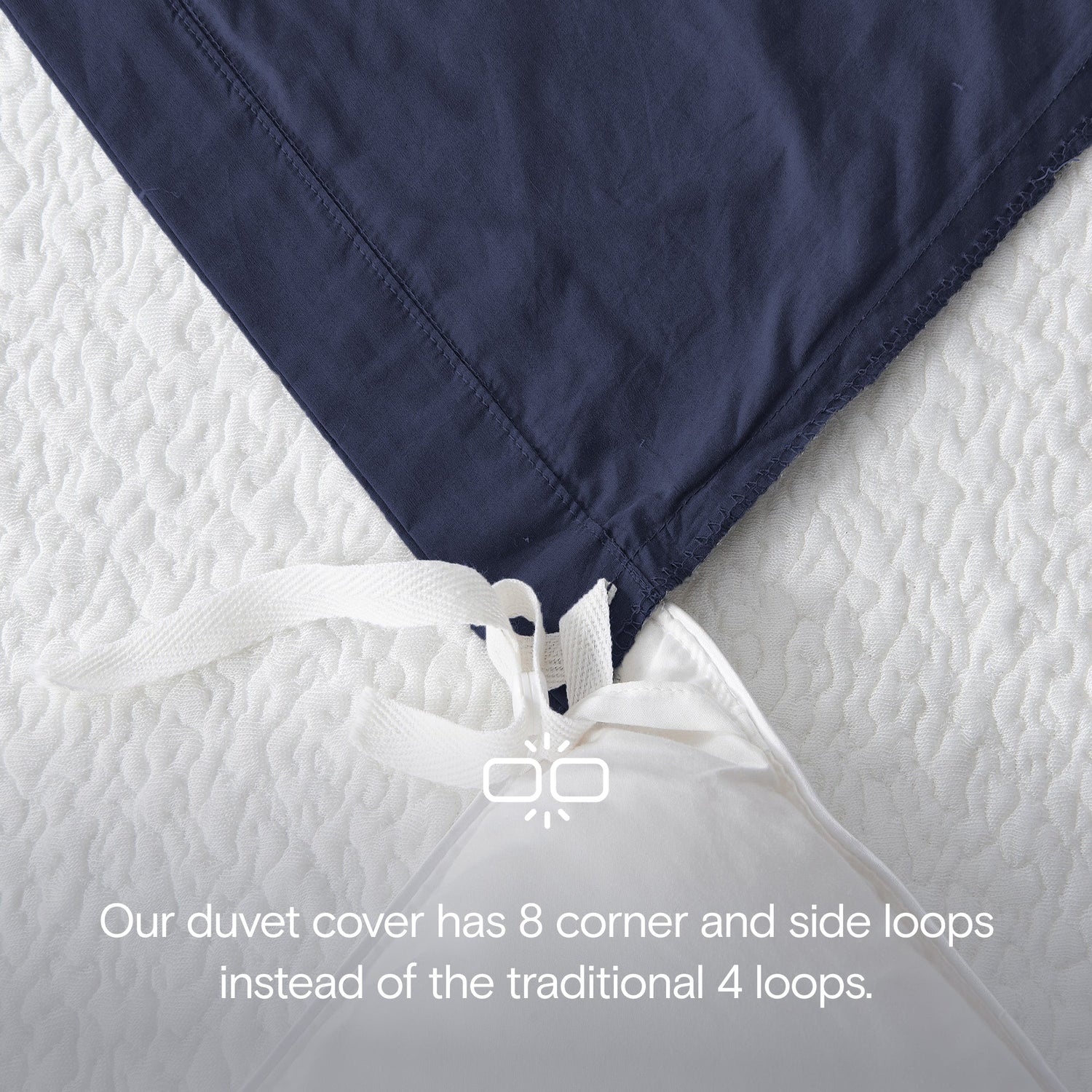 Navy blue duvet cover with white loops on a white background