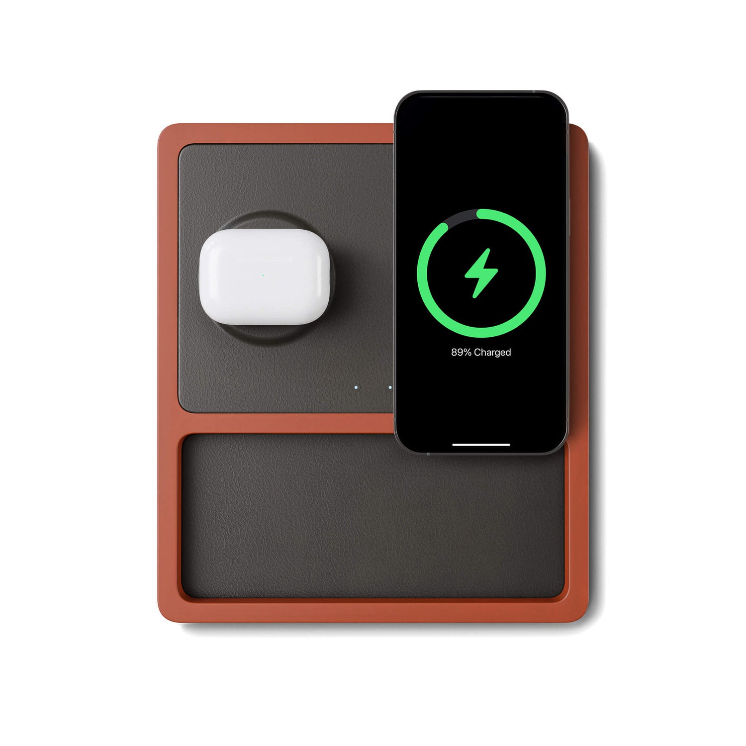 A black and oak wood 2-in-1 MagSafe wireless charging pad with a smartphone and earbuds being charged on it.