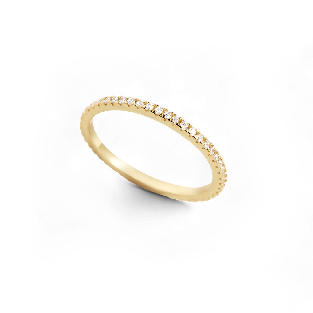 Gold ring with small diamonds on a white background