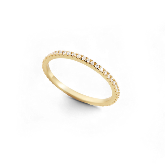 Gold ring with small diamonds on a white background