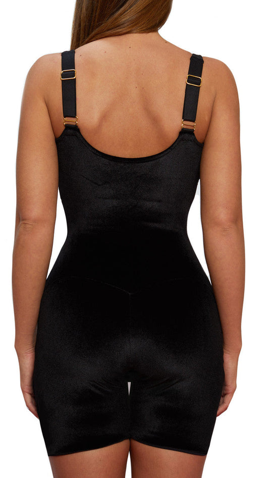 A model wears a black velvet bodysuit on a white background