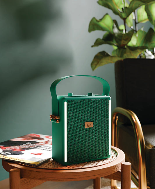 Red portable speaker with textured gold side on a white background