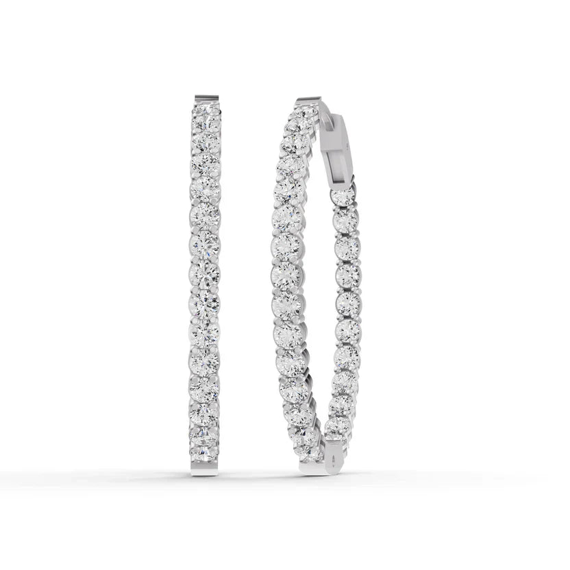 Pair of diamond hoop earrings on a white background