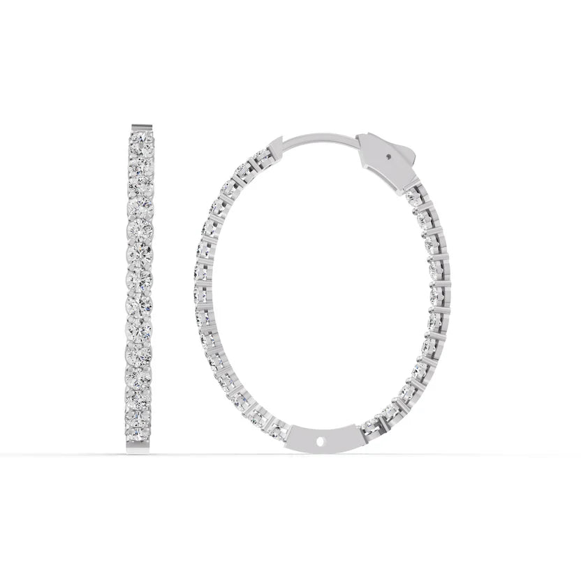 Silver hoop earrings with clear gemstones on a white background