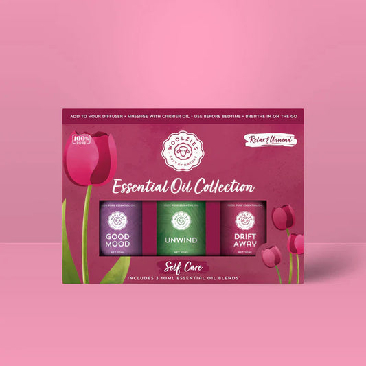 Wolz & Co Essential Oil Collection packaging with three bottles on a pink background