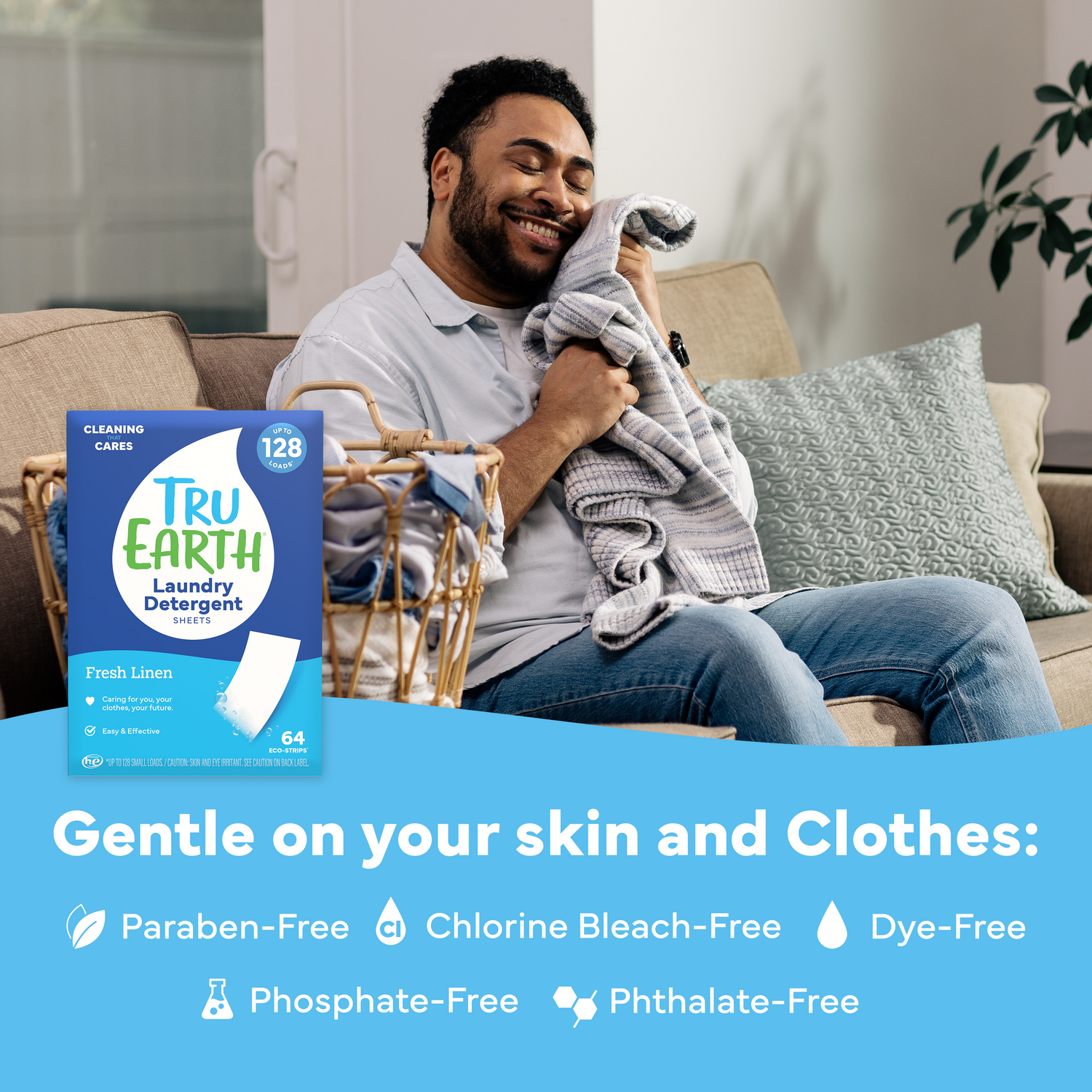 Man sitting on a couch holding a blanket with Tru Earth laundry detergent packaging displayed.