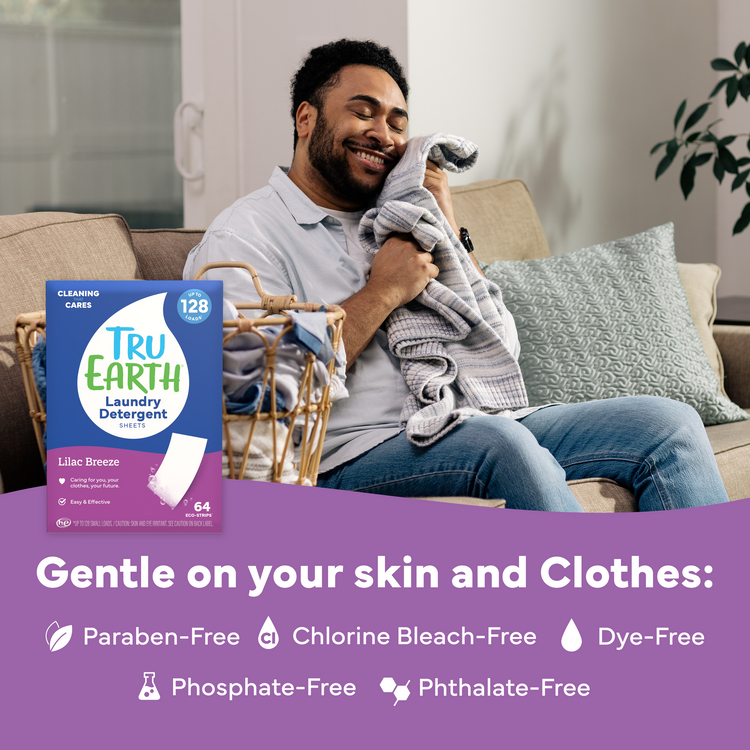 Man holding a blanket with Tru Earth laundry detergent packaging in the foreground