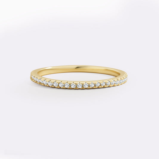 Gold ring with small diamonds on a white background