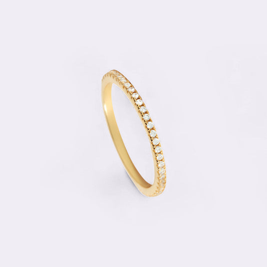 Gold ring with small diamonds on a white background