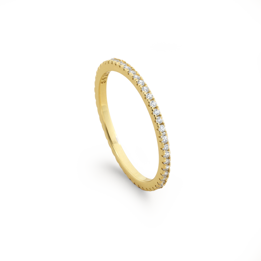 Gold ring with small diamonds on a white background