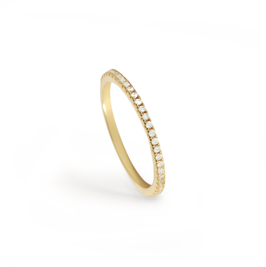 Gold ring with small diamonds on a white background