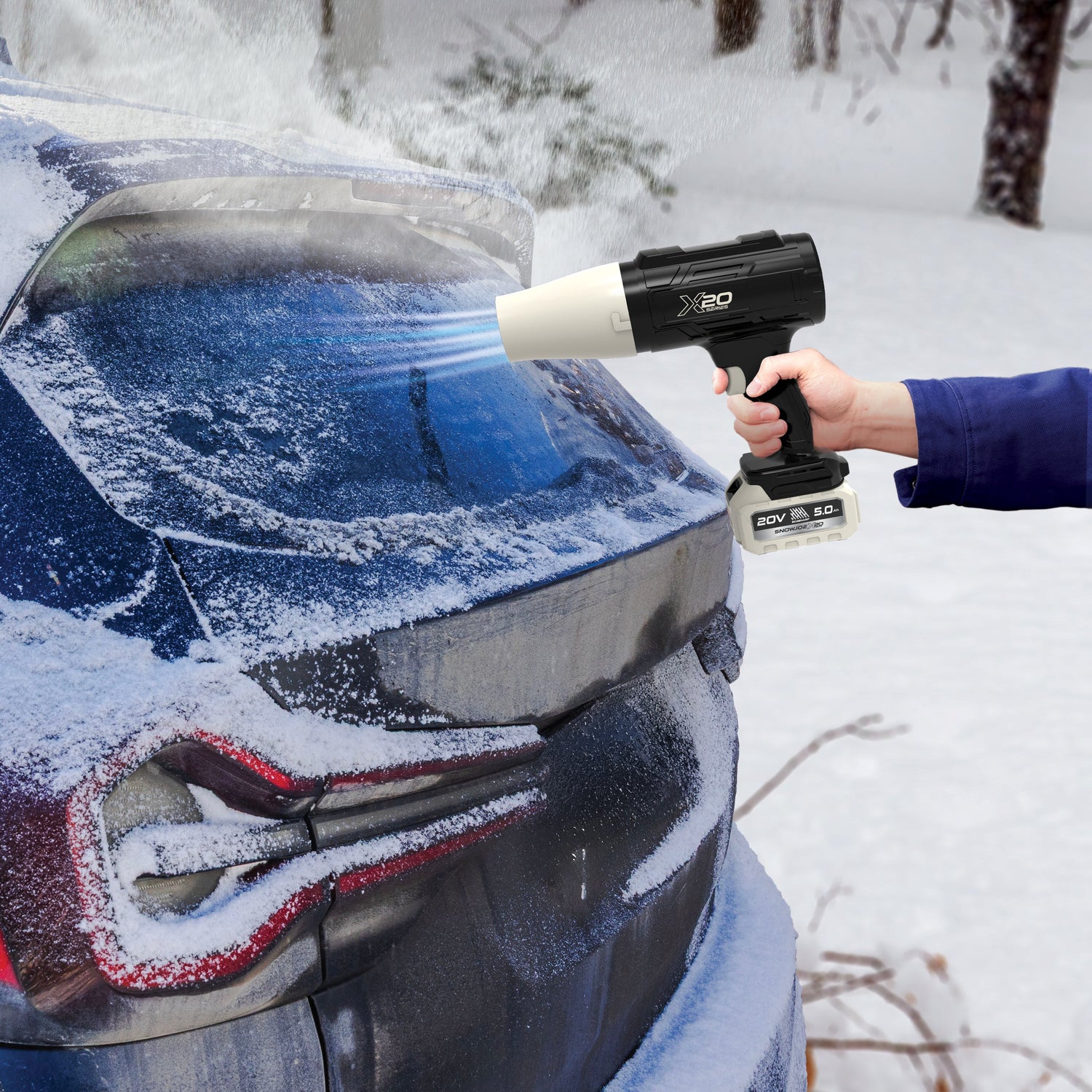 Person using a snow removal tool on a car's windshield in a snowy setting