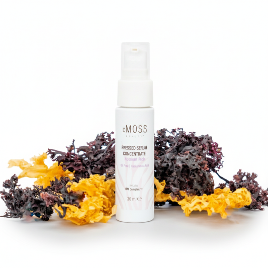 White serum bottle with seaweed on a white background