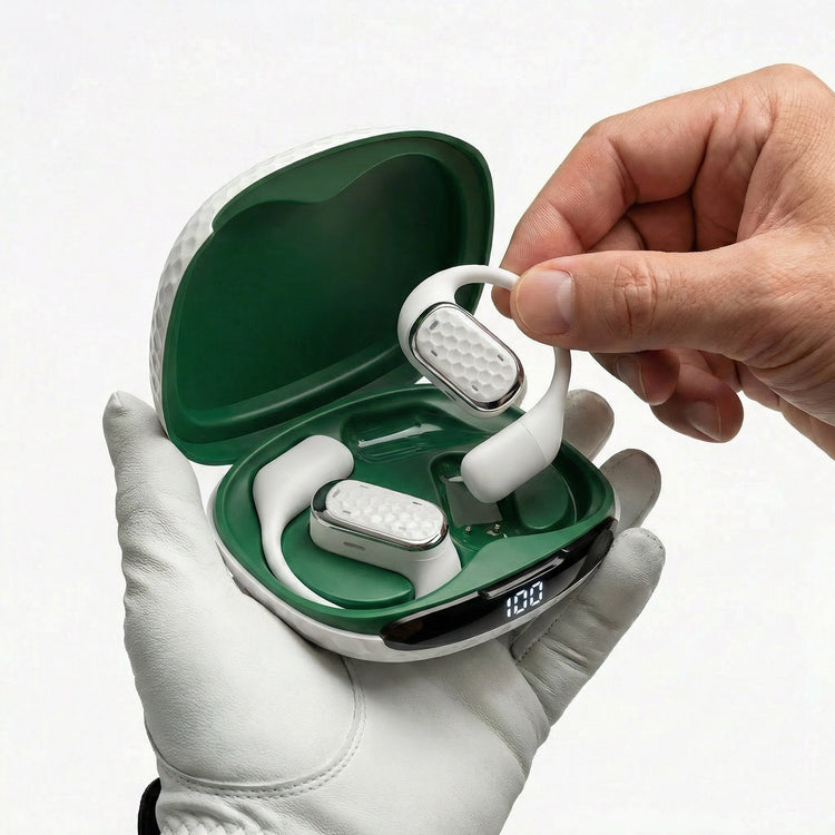 White wireless earbuds being taken out of a green charging case by a hand.