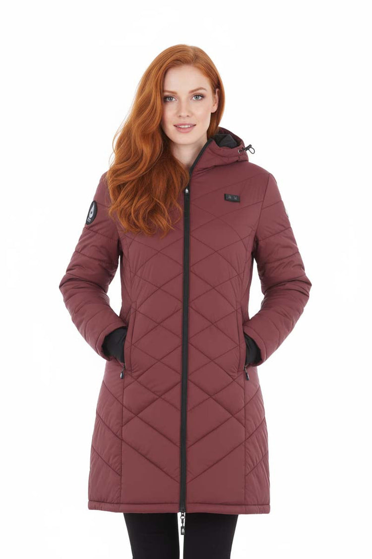 Woman wearing a maroon quilted coat on a white background
