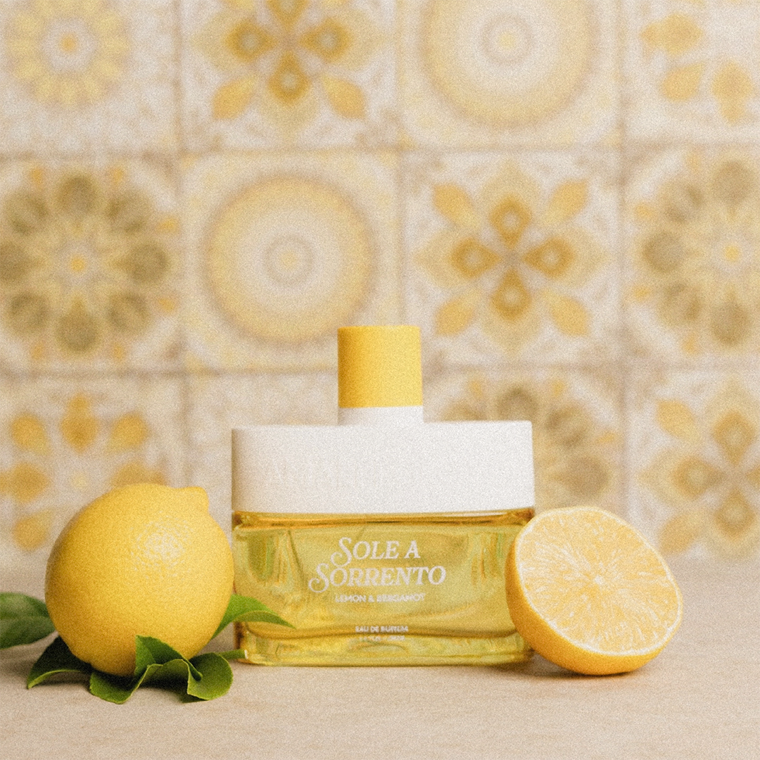 Sole a Sorrento perfume bottle with lemons on a decorative background