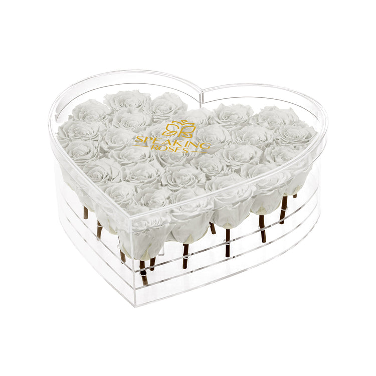 Heart-shaped transparent box with white roses and 'Speaking Roses' logo on a white background