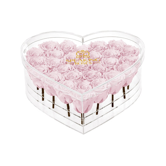 Heart-shaped box with pink roses and 'Bouqs' logo on a white background