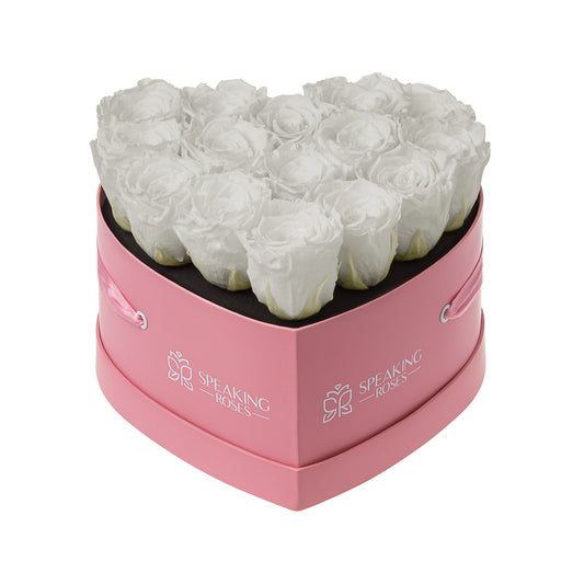 Heart-shaped pink box with white roses and 'Speaking Roses' branding on a white background
