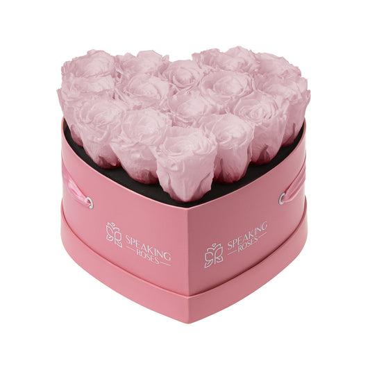 Heart-shaped pink rose box with 'Speaking Roses' branding on a white background