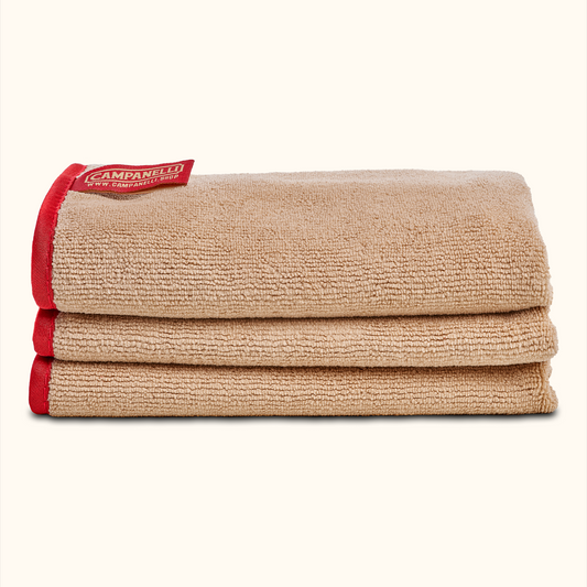 Set of four beige placemats with red edges and a visible brand logo on a white background
