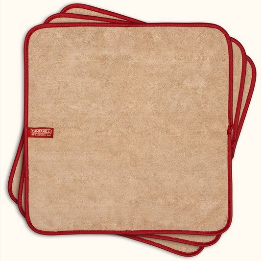 Set of four beige placemats with red edges and a visible brand logo on a white background