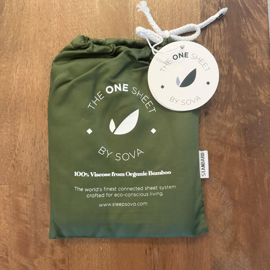 Green packaging of 'The One Sheet by SOVA' on a wooden surface