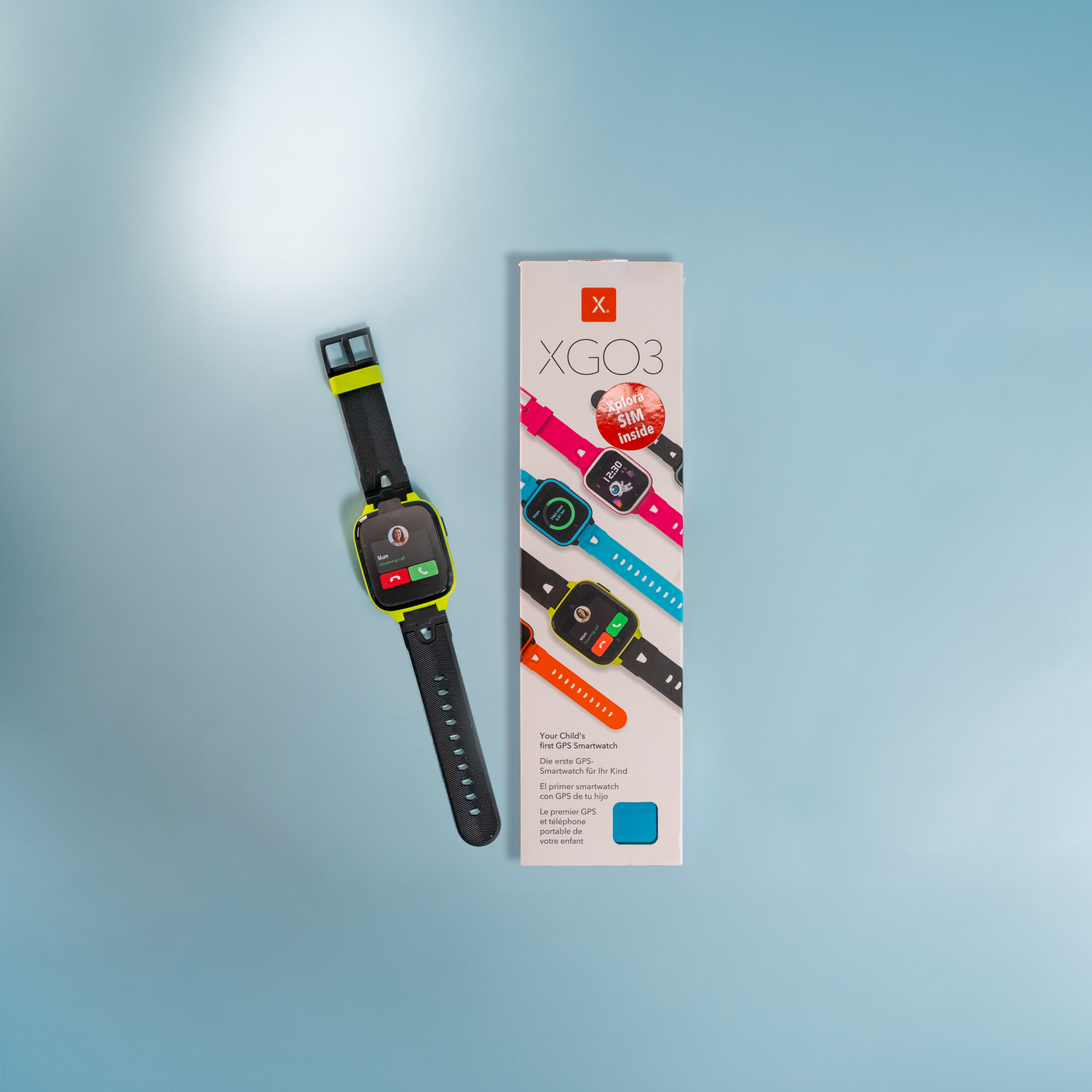 Smartwatch with a packaging box labeled 'XGO3' on a light blue background