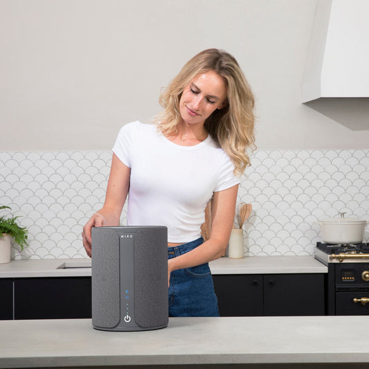 Miko smart device with smartphone displaying app interface on a white background