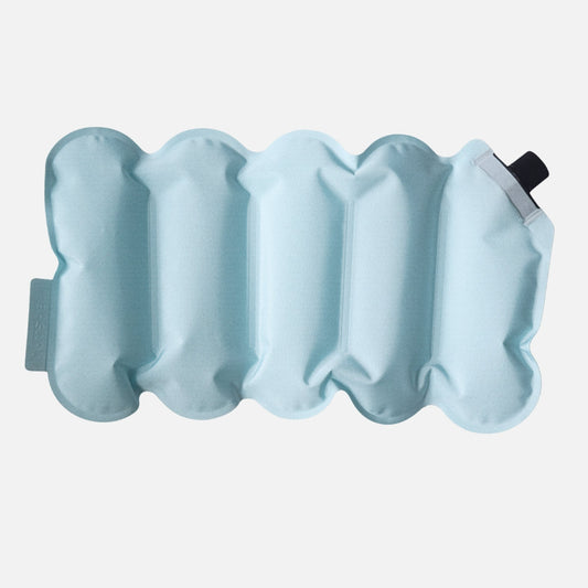 Inflatable light blue cushion with a valve on a white background