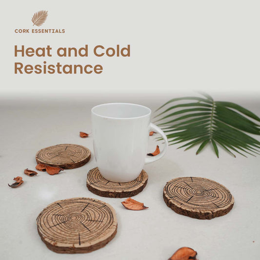 Set of three tree-ring patterned coasters with a glass of dark liquid on a white background